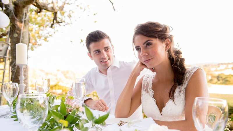 A bride has sparked debate after insisting her wedding guests pay for their own meal on her big day (Image: Getty Images/Loop Images)