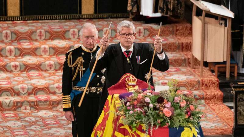 The Lord Chamberlain break his wand of office next to King Charles at the late Queen