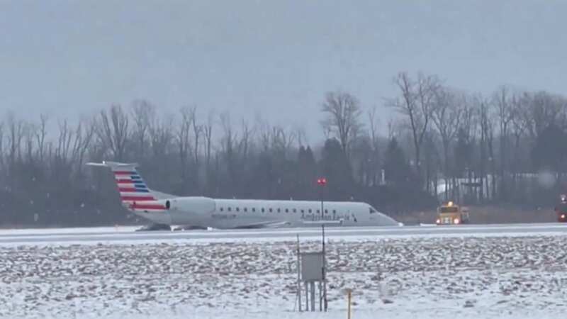 Terrifying moment American Airlines plane skids off snowy runway into grass