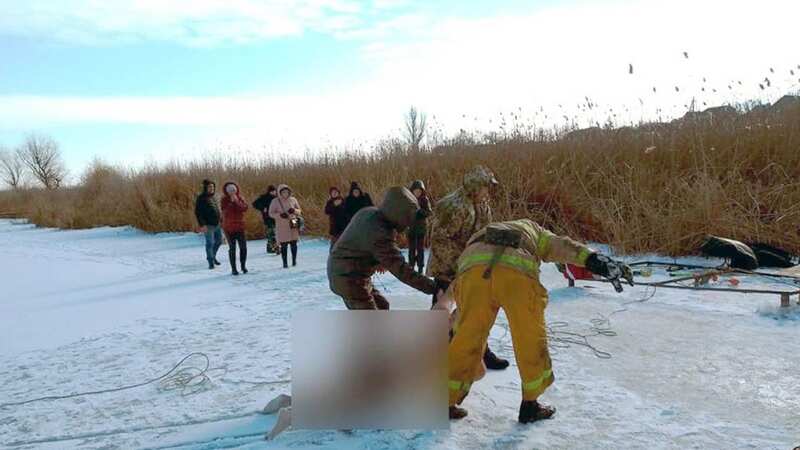 Moment Ukrainian man asks wife to film him jumping into frozen river