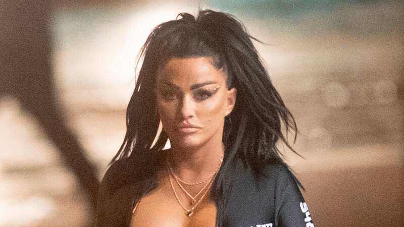 Katie Price donned a plunging black catsuit for her night out (Image: SplashNews.com)