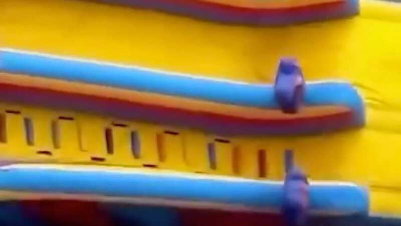Stomach-churning moment bouncy castle blows across motorway with child inside