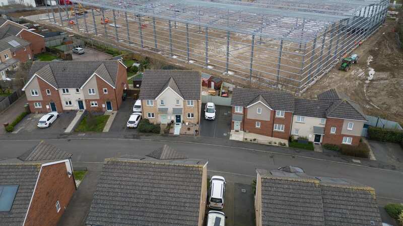 The massive factory being built behind people