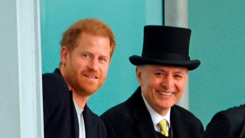 A smiling Prince Harry at Heathrow Airport before travelling back to California (Image: w8media)