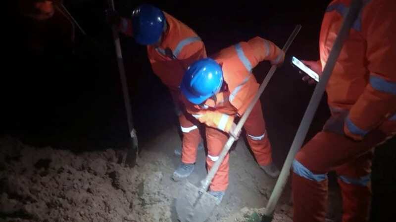 Rescuers dig in an attempt to reach their trapped friends beneath the earth (Image: Xinhua/REX/Shutterstock)