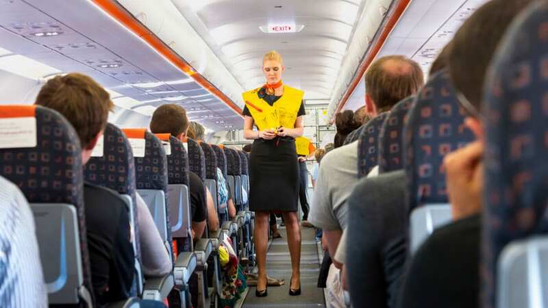 A flight attendant reveals the fascinating reason cabin crew sit on hands during flights (Image: UCG/Universal Images Group via Getty Images)