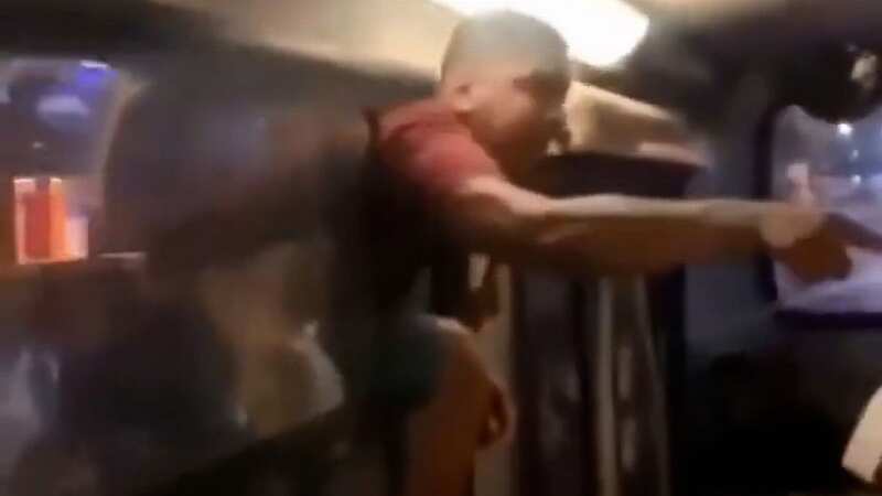 Passengers are screaming as a man tries to climb into a bus to confront who he thought was his girlfriend