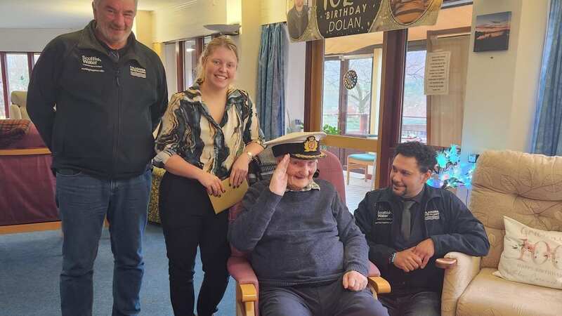 CWA site agents Alistair Purvis (left) and Omer Satmis (right) surprised Dolan MacAskill (centre) with a cake for his birthday, alongside SHE advisor Jana Brady (Image: Scottish Water/SWNS)