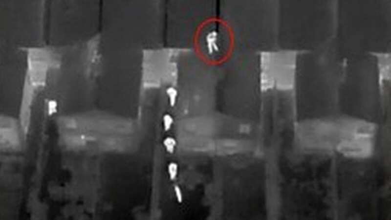 Moment on-the-run suspect is caught by police drone as he hides on roof