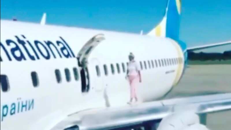 Mum walks out onto aeroplane wing on runway moaning she