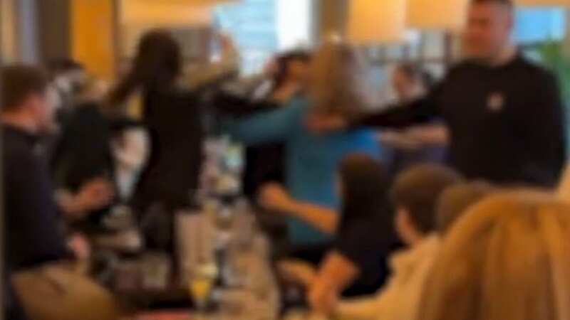 Fight breaks out in busy restaurant as parents shield crying child from brawl