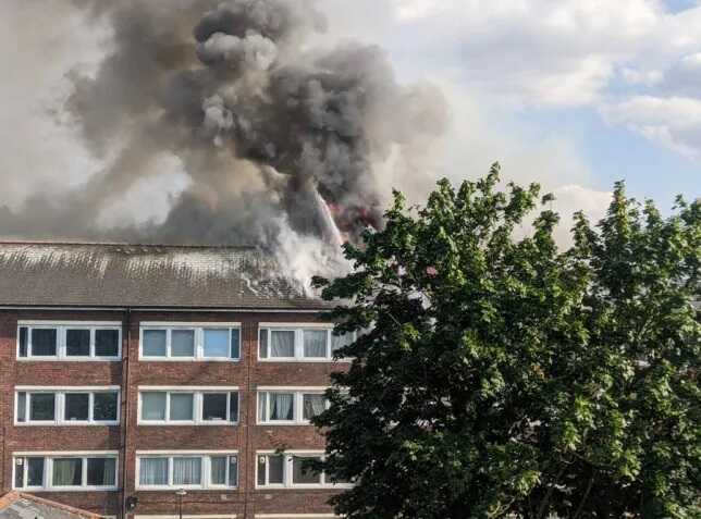 Huge fire tears through east London flats, causing roof collapse