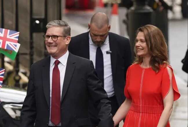 The newly elected PM was beaming as he walked up to Downing Street (Picture: PA)