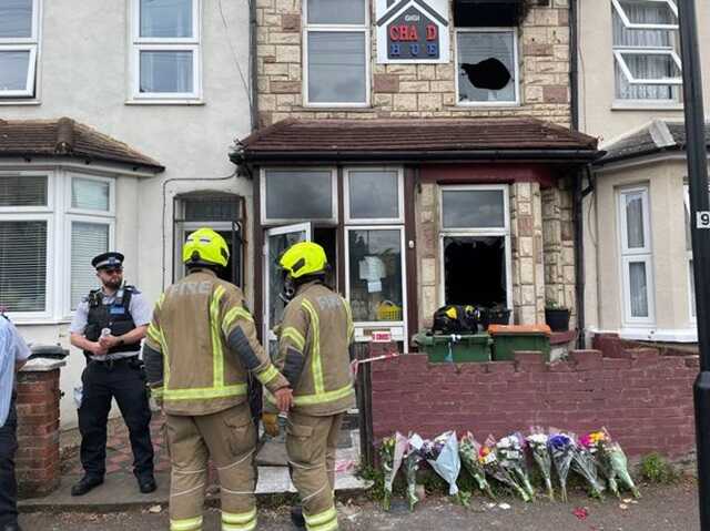 The house had two windows and the front door glass smashed by nearby residents in an attempt to save the family (   Image:  PA)