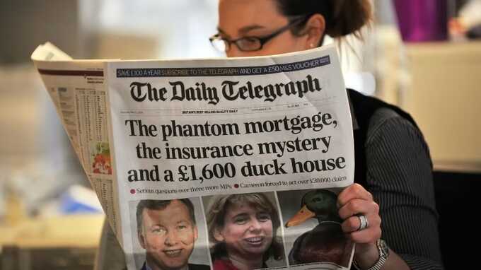 A reader with a Daily Telegraph edition. Pic: AFP