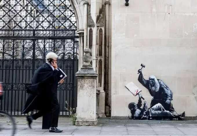 Banksy’s latest piece on London court building covered and guarded