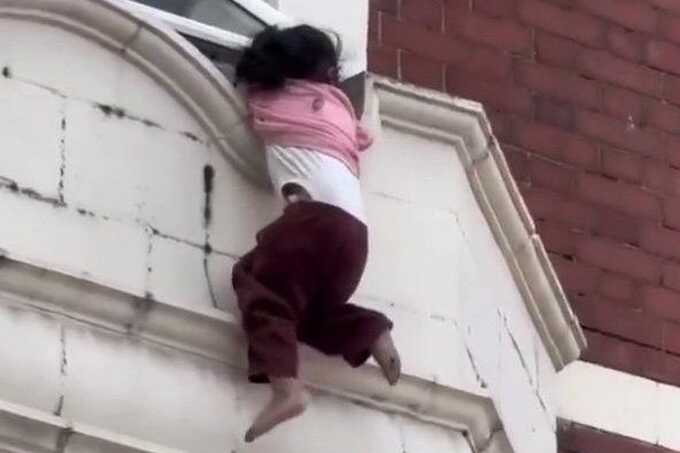 Stranger and police officer catch toddler as she falls from London window ledge