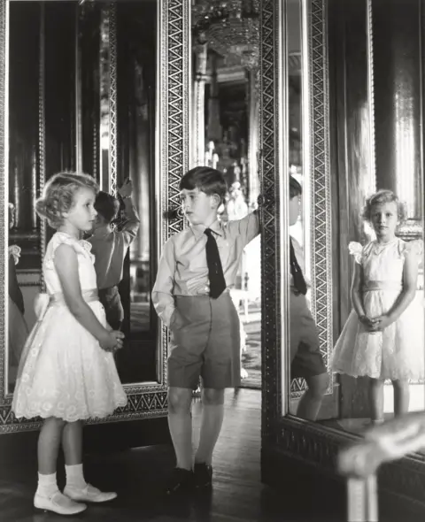 Lord Snowdon Princess Anne and King Charles as young children, standing beside a mirror in Buckingham Palace dqxikeidqkikdinv