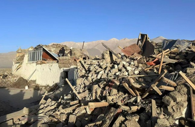 In this photo released by Xinhua News Agency, people stand amidst damaged houses in the aftermath of an earthquake in Tonglai Village, Changsuo Township of Dingri in Xigaze, southwestern China&rsquo;s Tibet Autonomous Region on Tuesday, Jan. 7, 2025. (Xinhua via AP)