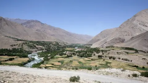 A file picture of the Sangin valley in Afghanistan with arid mountains in the background and a fertile valley in the foreground dqxikeidqkikdinv