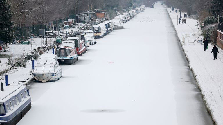 People walk along the towpath of a frozen and snow-covered section of the Bridgewater Canal in Manchester.
Pic: Reuters dqxikeidqkikdinv
