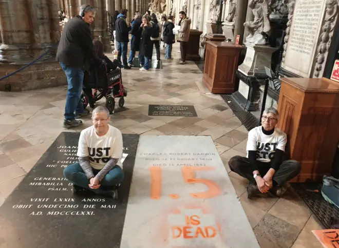 Members of the group sit by Darwin’s grave in their latest protest dqxikeidqkikdinv