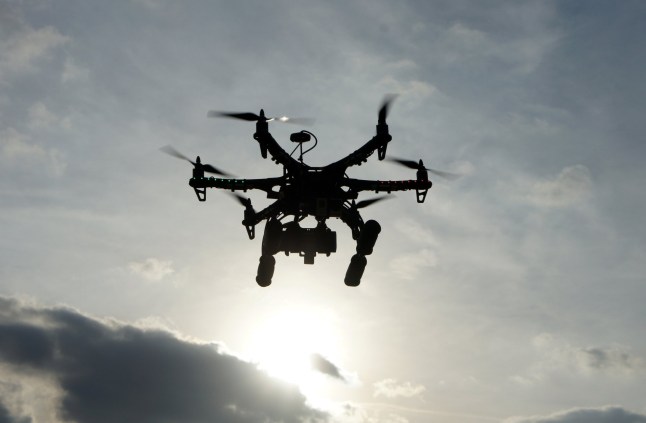 Hexacopter taking aerial photos at sunset. Also known as a drone or UAV (Unmanned Aerial Vehicle). dqxikeidqkikdinv