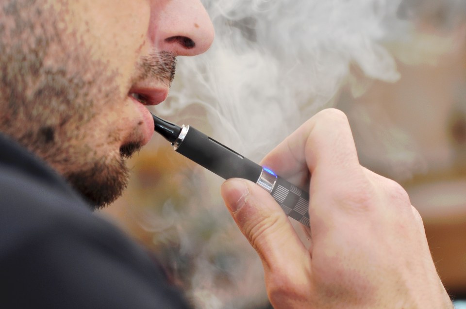 Man vaping an e-cigarette. dqxikeidqkikdinv