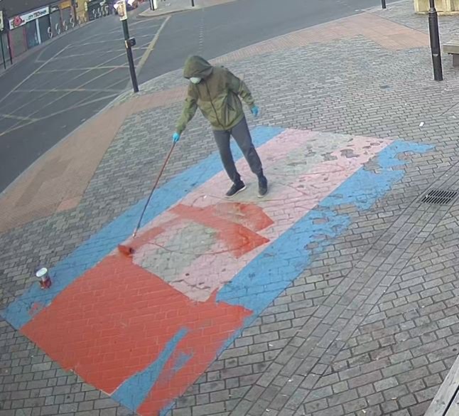 Image released as investigation into Newham Pride flag vandalism continues Detectives who are investigating a linked series of homophobic hate crimes in Newham have released an image of a person they would like to speak to. Police were called early in the morning of Sunday, 23 June after a large painted Pride flag on the pavement outside Forest Gate Railway Station, in Woodgrange Road, E7, had been vandalised. A further report was made on the morning of Wednesday, 26 June regarding criminal damage to two other flags at the same location. All three flags were damaged with red paint. Detective Inspector James Rush from the North East area?s Public Protection team, who is leading the investigation, said: ?We believe that the same person committed these offences, which we now know took place at between 05:00hrs and 05:30 on Sunday, 23 June and at about the same time on Wednesday, 26 June. ?As our investigation continues at pace, we have today issued an image of a person we would like to speak to in connection with the offences. The image was captured on Wednesday, 26 June. ?While the person?s face is covered, we hope that someone who lives or works in the area may recognise the individual from their distinctive clothing. If you think you may recognise the person shown in the image ? maybe they are a customer at your shop, or live nearby ? I would urge you to contact my team. ?I understand providing information to police can be intimidating, but I can reassure the public that any information provided will be handled sensitively. If you would rather provide information anonymously, please contact Crimestoppers.? No arrests have been made and enquiries continue. Anyone with information can contact police by calling 101 or visiting www.met.police.uk, quoting reference 2433/23Jun. Alternatively, you can call the independent charity Crimestoppers anonymously on 0800 555 111 or visit crimestoppers-uk.org. dqxikeidqkikdinv