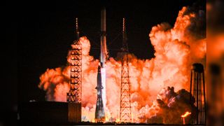 a white rocket launches into a dark night sky dqxikeidqkikdinv