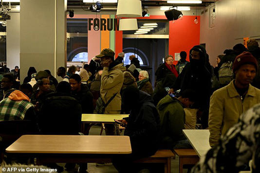 Dozens of migrants, the majority of whom are from African countries, are seen in an area of the&nbsp;Gaite Lyrique cultural centre