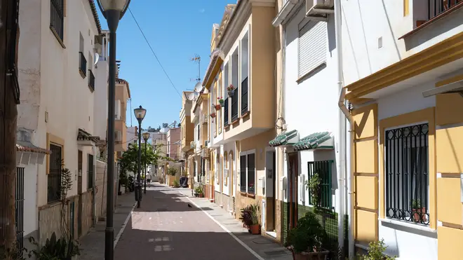 Residential properties on a street in the Pedregalejo Playa area in Malaga, Spain. dqxikeidqkikdinv