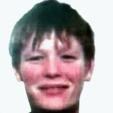 Shutterstock Fred Barras is seen in a blurry photo. He looks like a young teenager with short dark hair dqxikeidqkikdinv