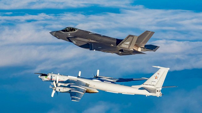 In this March 2020 handout image from the Norwegian Armed Forces a Norwegian F-35 fighter jet intercepts a Russian Tupolev TU-142 (Bear-J)near Norwegian air space along the Norwegian / Russian border. The "Bear-J" aircraft is being used as a communications relay and control center for Russian submarines according to the Norwegian Armed Forces. (Photo by Handout / Forsvaret / AFP) / RESTRICTED TO EDITORIAL USE - MANDATORY CREDIT "AFP PHOTO / FORSVARET " - NO MARKETING NO ADVERTISING CAMPAIGNS - DISTRIBUTED AS A SERVICE TO CLIENTS (Photo by HANDOUT/Forsvaret/AFP via Getty Images) dqxikeidqkikdinv