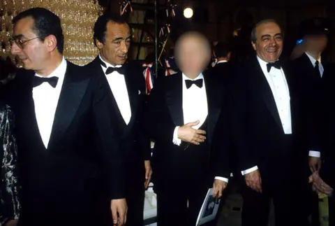 Shutterstock Ali with his brothers Salah and Mohamed (L-R). They are all dressed in black tie and Mohamed is smiling broadly at the camera.
dqxikeidqkikdinv