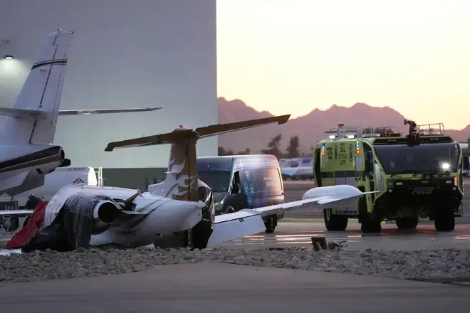 A crashed Learjet sits next to a plane it collided with as Scottsdale Airport dqxikeidqkikdinv