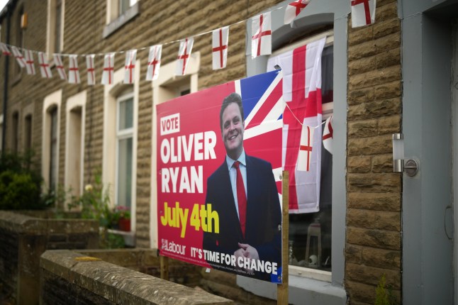 BURNLEY, ENGLAND - JUNE 25: An election placard for Labour candidate Oliver Ryan stands outside a home on June 25, 2024 in Burnley, England. When Burnley elected a Conservative MP in 2019, it was the first time in more than a century. Ahead of the general election on July 4th, electoral forecasts are predicting a Labour win, which would allow the party to replace another brick in its "red wall" of traditionally Labour-aligned constituencies across the Midlands and Northern England. (Photo by Christopher Furlong/Getty Images) dqxikeidqkikdinv