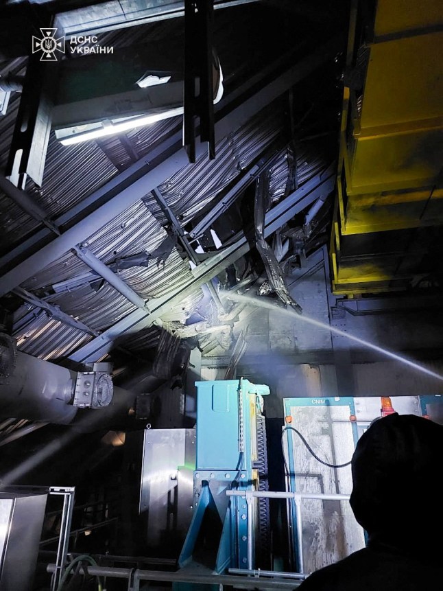 Firefighters work under the New Safe Confinement (NSC) structure that covers the old sarcophagus which confines the remains of the damaged fourth reactor, hit by a Russian drone strike, amid Russia&rsquo;s attack on Ukraine, at the Chornobyl Nuclear Power Plant, in Kyiv region, Ukraine February 14, 2025. Press service of the State Emergency Service of Ukraine/Handout via REUTERS ATTENTION EDITORS - THIS IMAGE HAS BEEN SUPPLIED BY A THIRD PARTY. DO NOT OBSCURE LOGO.