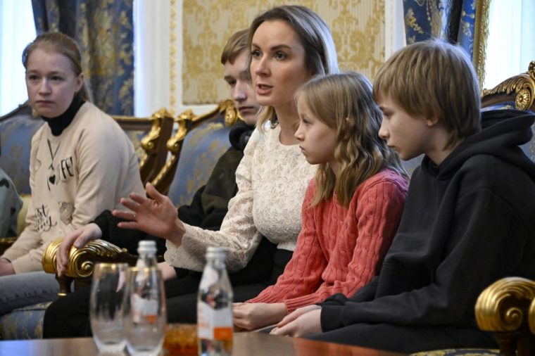 Russia’s presidential commissioner for children’s rights Maria Lvova-Belova sits with Ukrainian children before their departure to Ukraine from Russia under a deal brokered by Qatar, at the Qatari embassy in Moscow on February 19, 2024. (Photo by Alexander NEMENOV / AFP) (Photo by ALEXANDER NEMENOV/AFP via Getty Images)