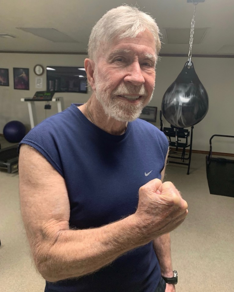 Chuck Norris flexing his bicep in a gym. dqxikeidqkikdinv